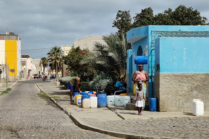 Sal island: Private Santa Maria City Tour, Street Art and Tapas - Old photographs, utensils, and a city view